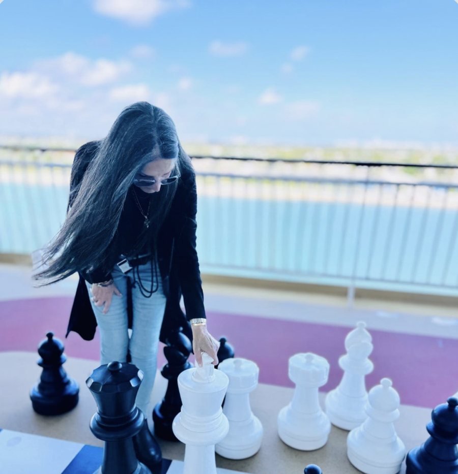 Angela Damianakis, LCSW at a giant chessboard — Got Counseling